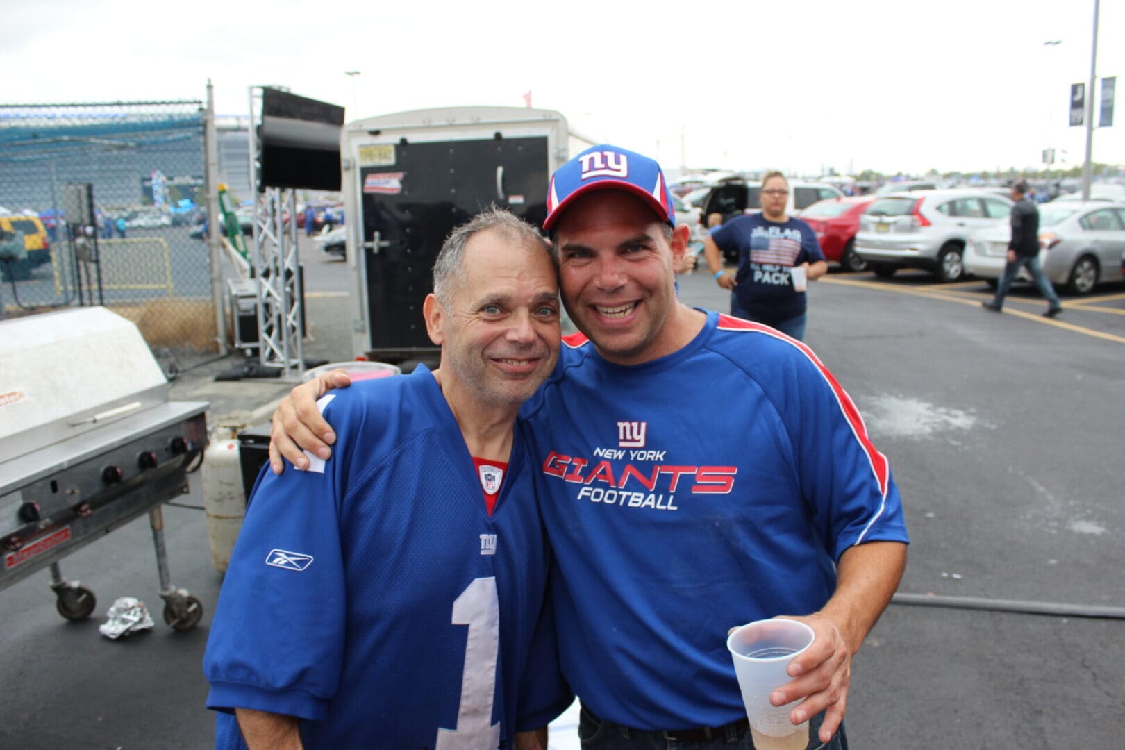 Two men in football jerseys are posing for a picture.