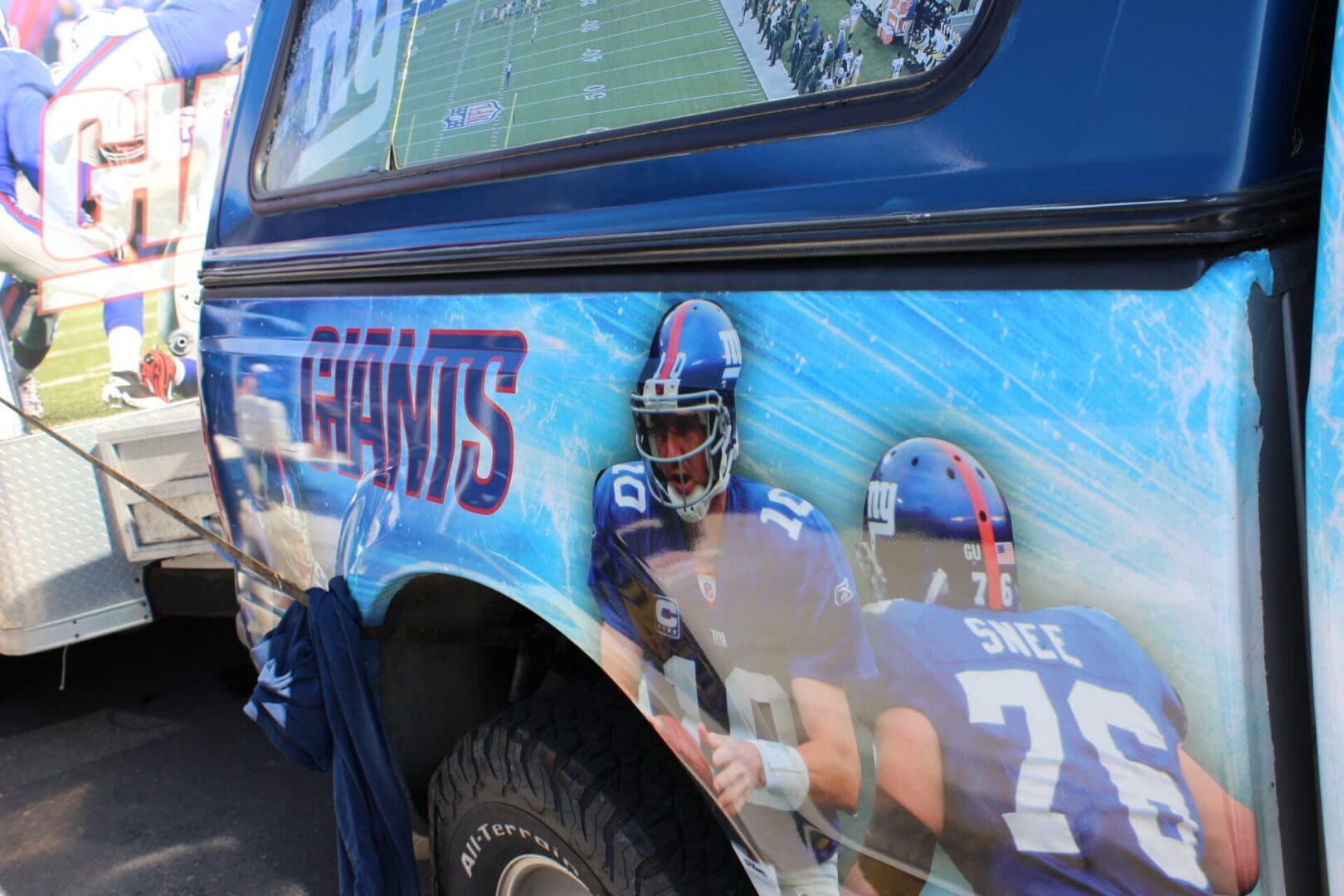A truck with a picture of a football player on it.